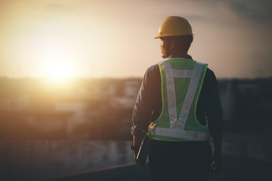 Engineer on a construction site at dusk