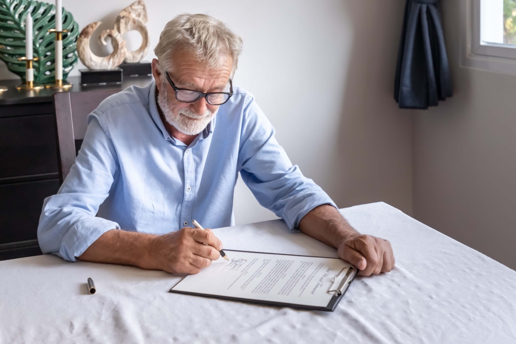 Senior citizens examining and signing a document Senior citizens examining and signing a document