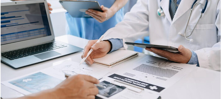 Doctors examining medical records of a silicosis patient